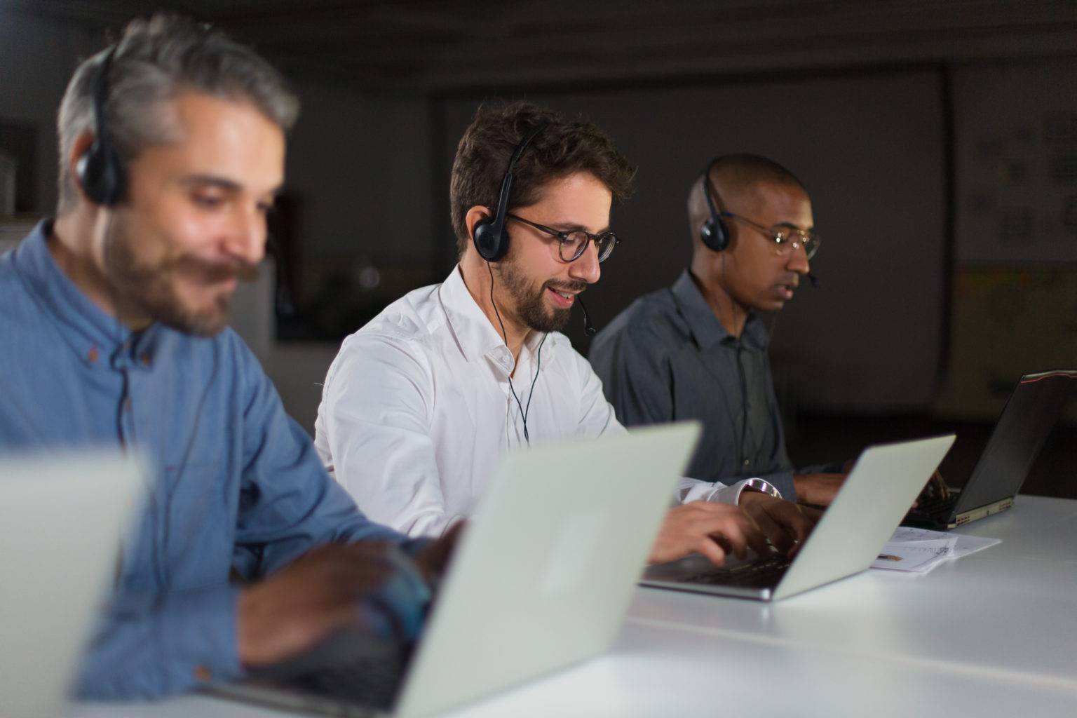 Cheerful call center operators during working process